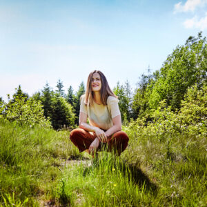 Caroline Marie Brooks kneeling in a field
